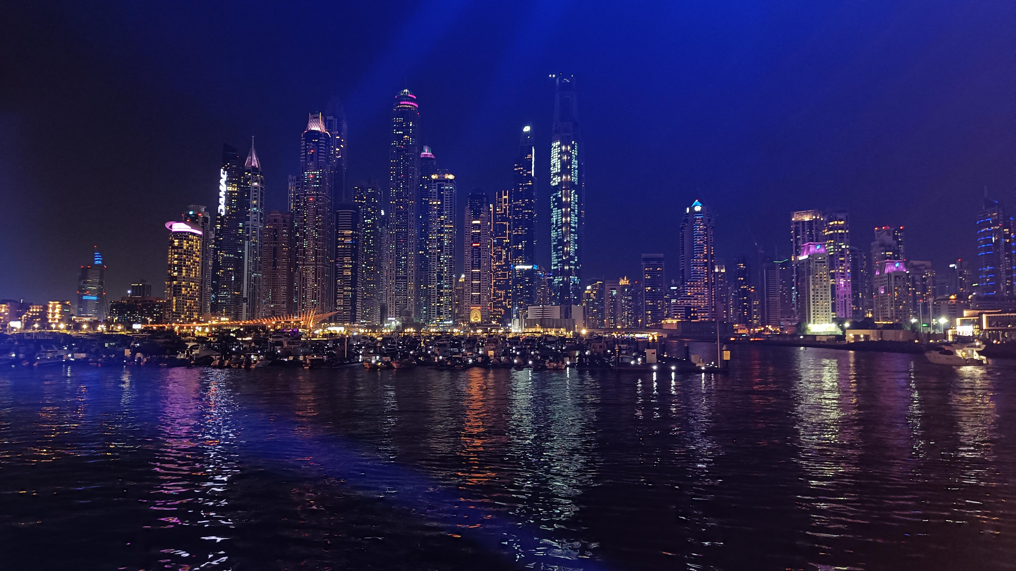 Traditional Dhow Cruise boat in Dubai Marina - evening dinner cruise with city lights