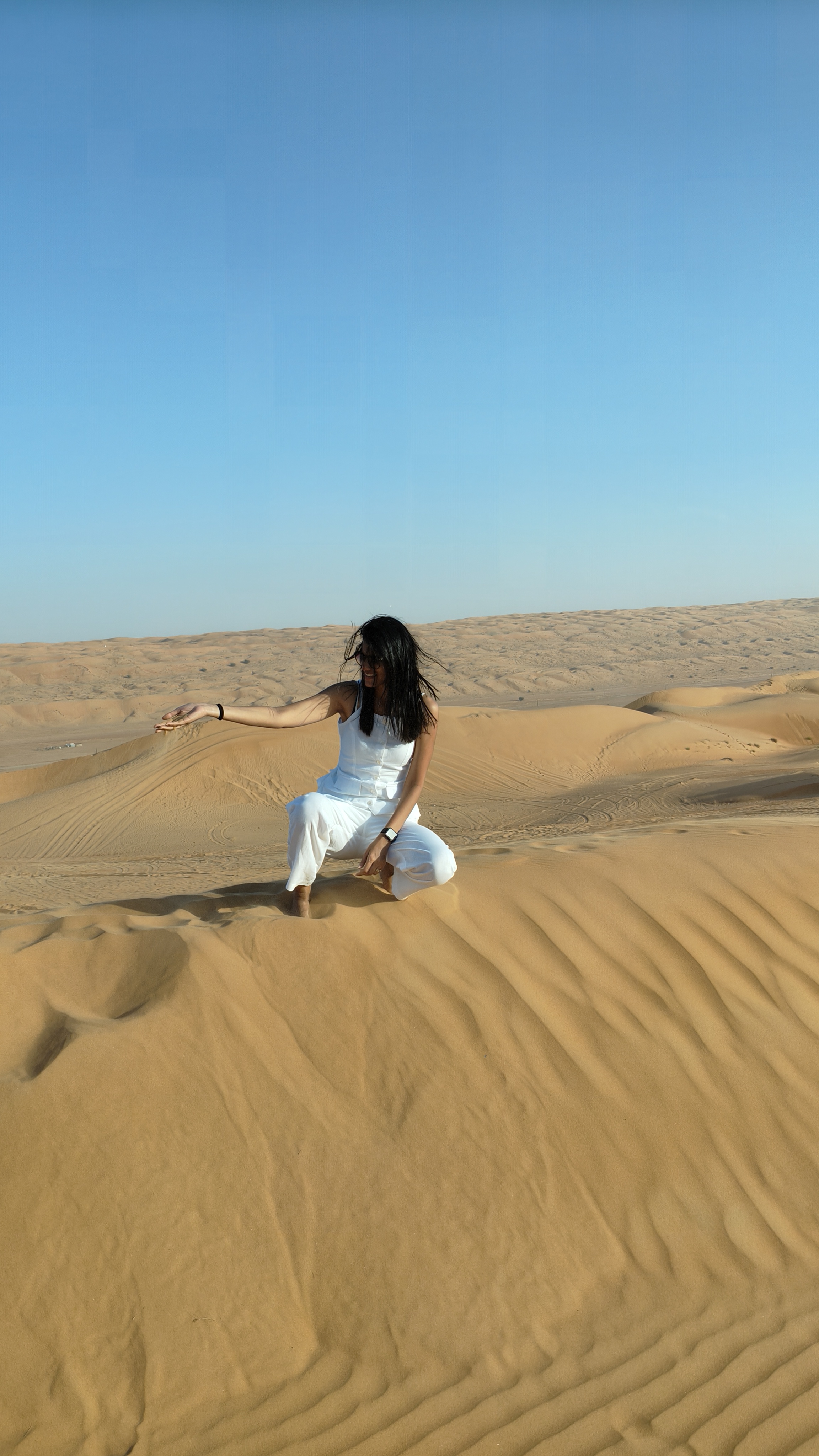 Pankhuri using the sand to determine the direction of the wind - to help her bowl the perfect outswinger