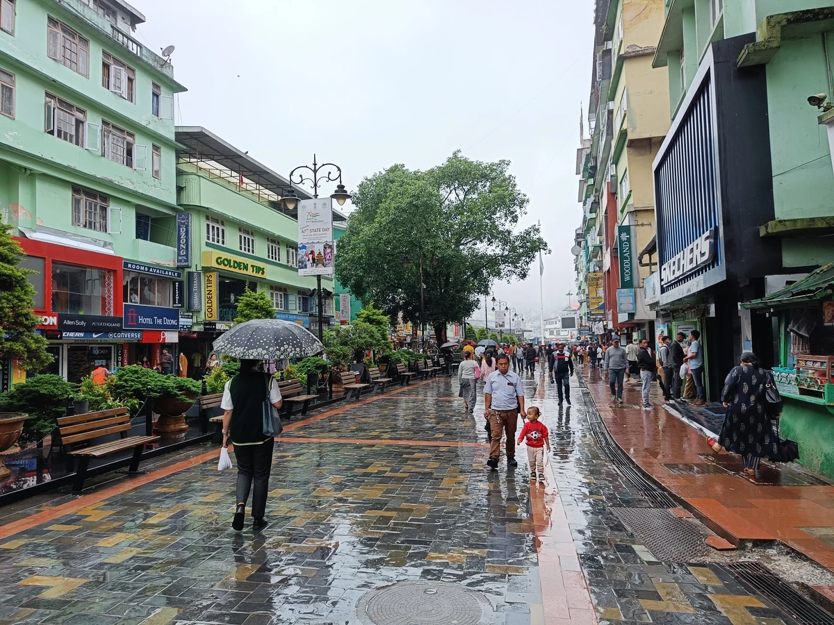 Panoramic view of Gangtok's Mall Road with vibrant shops and mountain backdrop