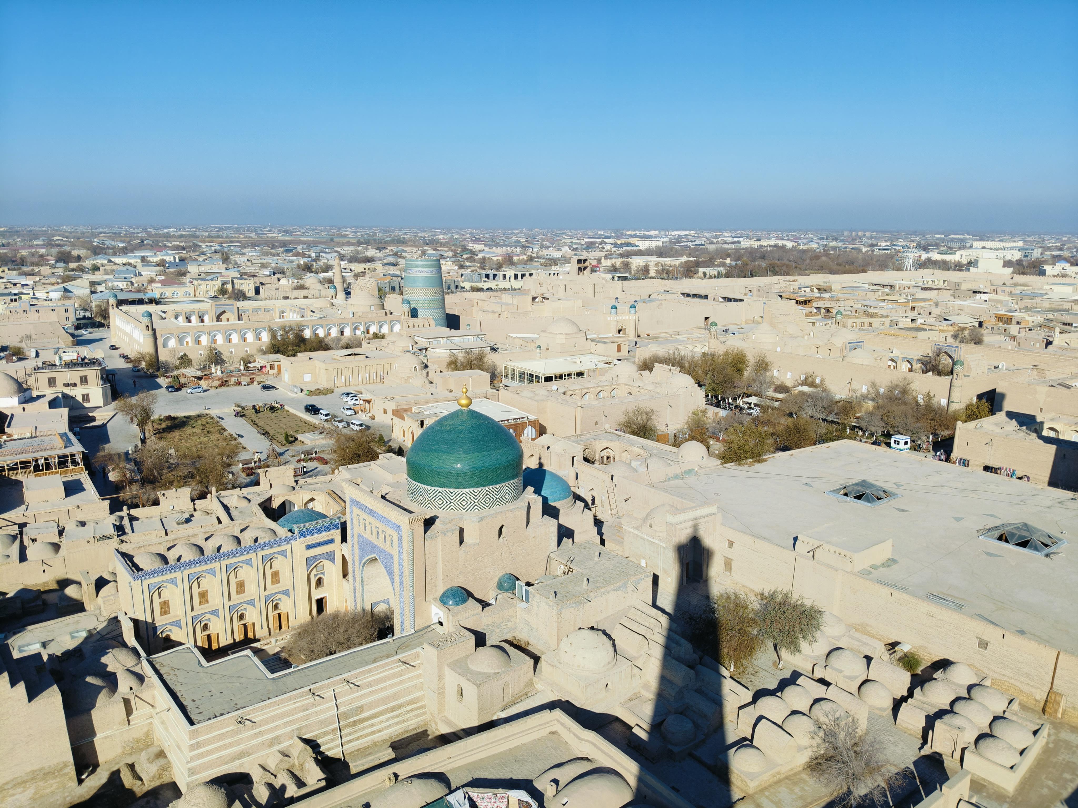 Panoramic 360-degree view of Khiva from Islam Khoja Minaret - breathtaking vista of UNESCO World Heritage Site showcasing clay-colored buildings, minarets, and surrounding desert landscape