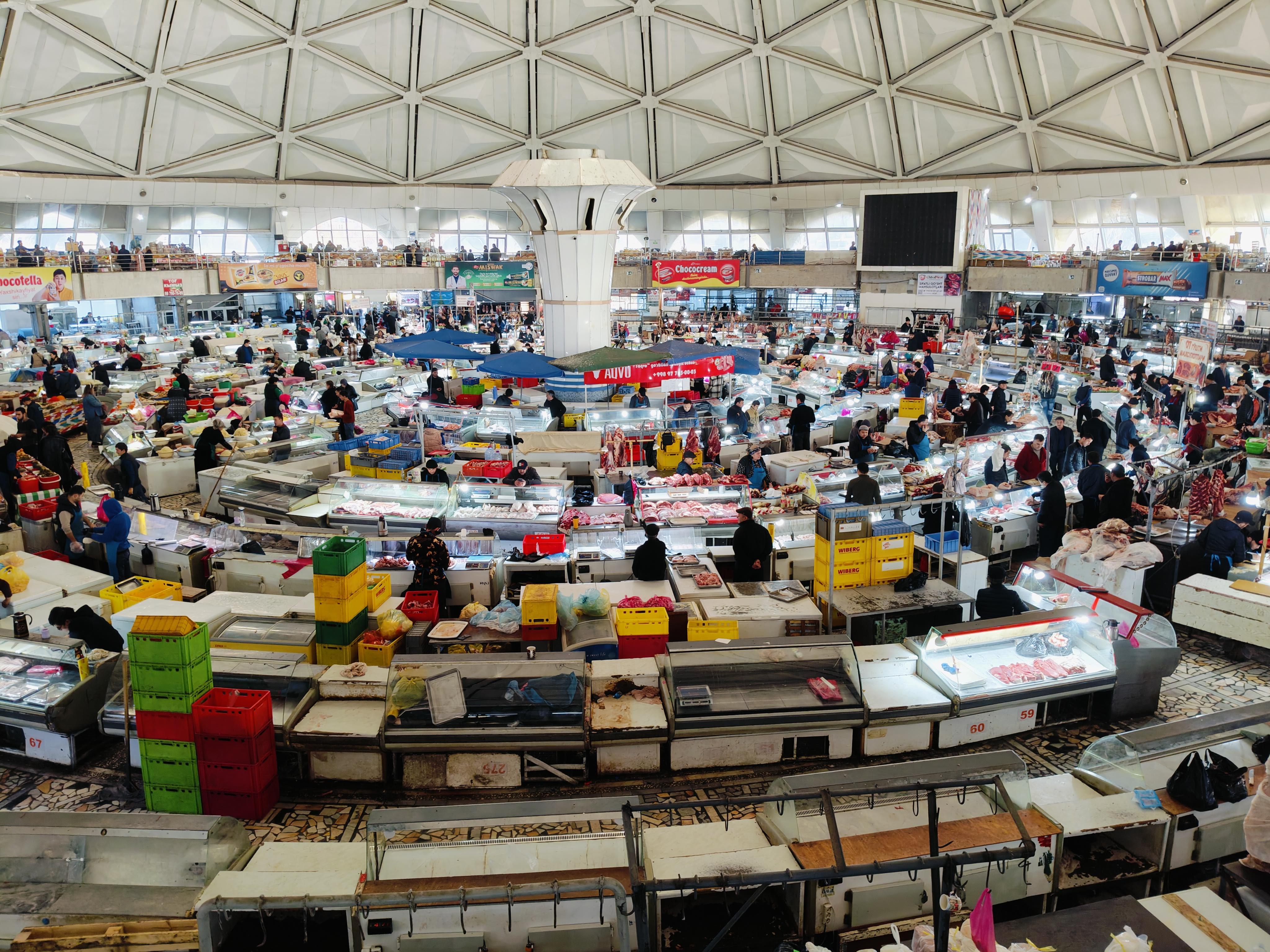 Grand interior dome of Chorsu Bazaar in Tashkent - Uzbekistan's largest traditional market featuring impressive Soviet-era architecture and bustling trade areas dating back centuries