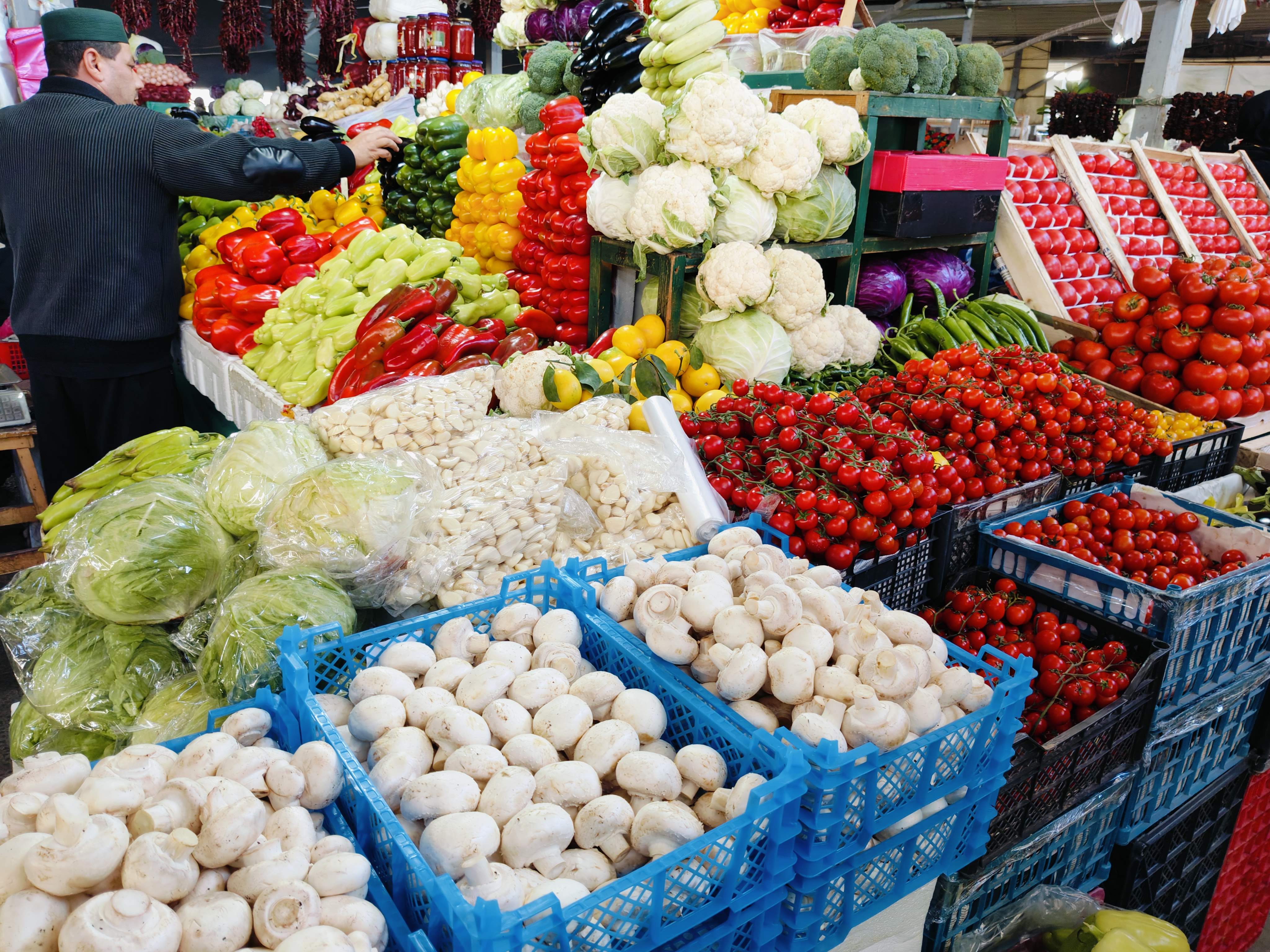 Vibrant display of oversized fresh produce in Uzbekistan market - exceptional quality fruits and vegetables showcasing the country's agricultural abundance and farm-to-table food culture