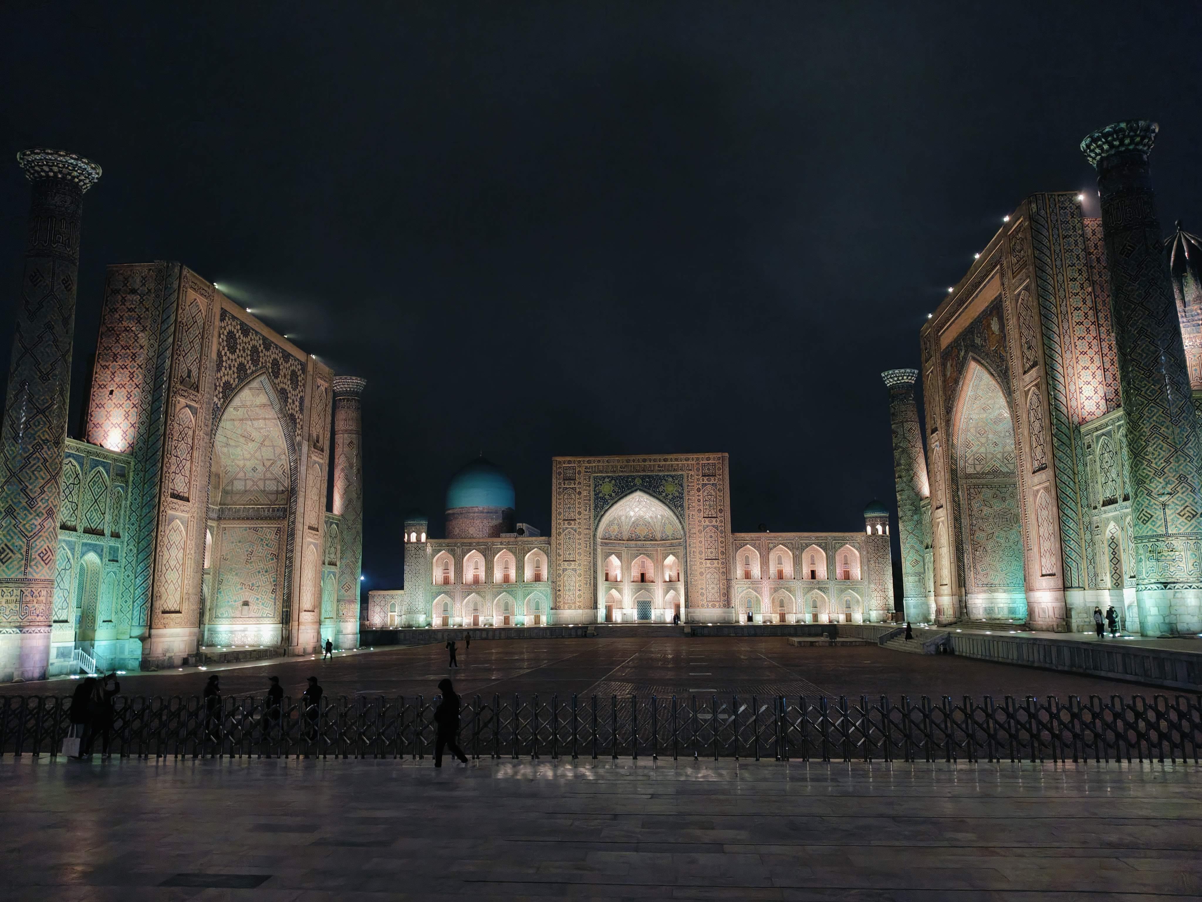 Spectacular night view of illuminated Registan Square in Samarkand, Uzbekistan - majestic madrasahs and minarets under evening lights