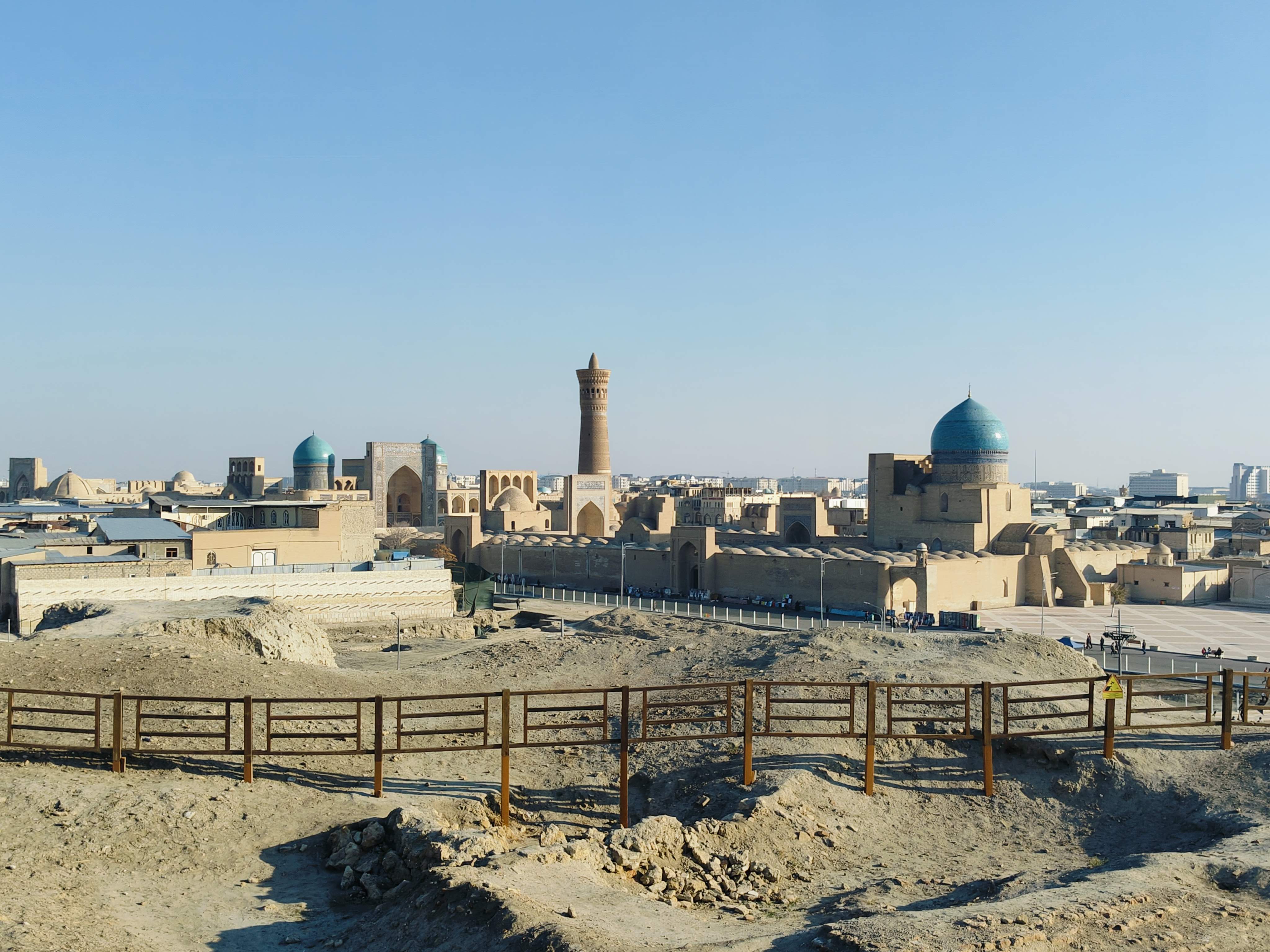 Panoramic aerial view of Old Bukhara from the top of the Ark fortress - historic Silk Road city skyline with domes and minarets