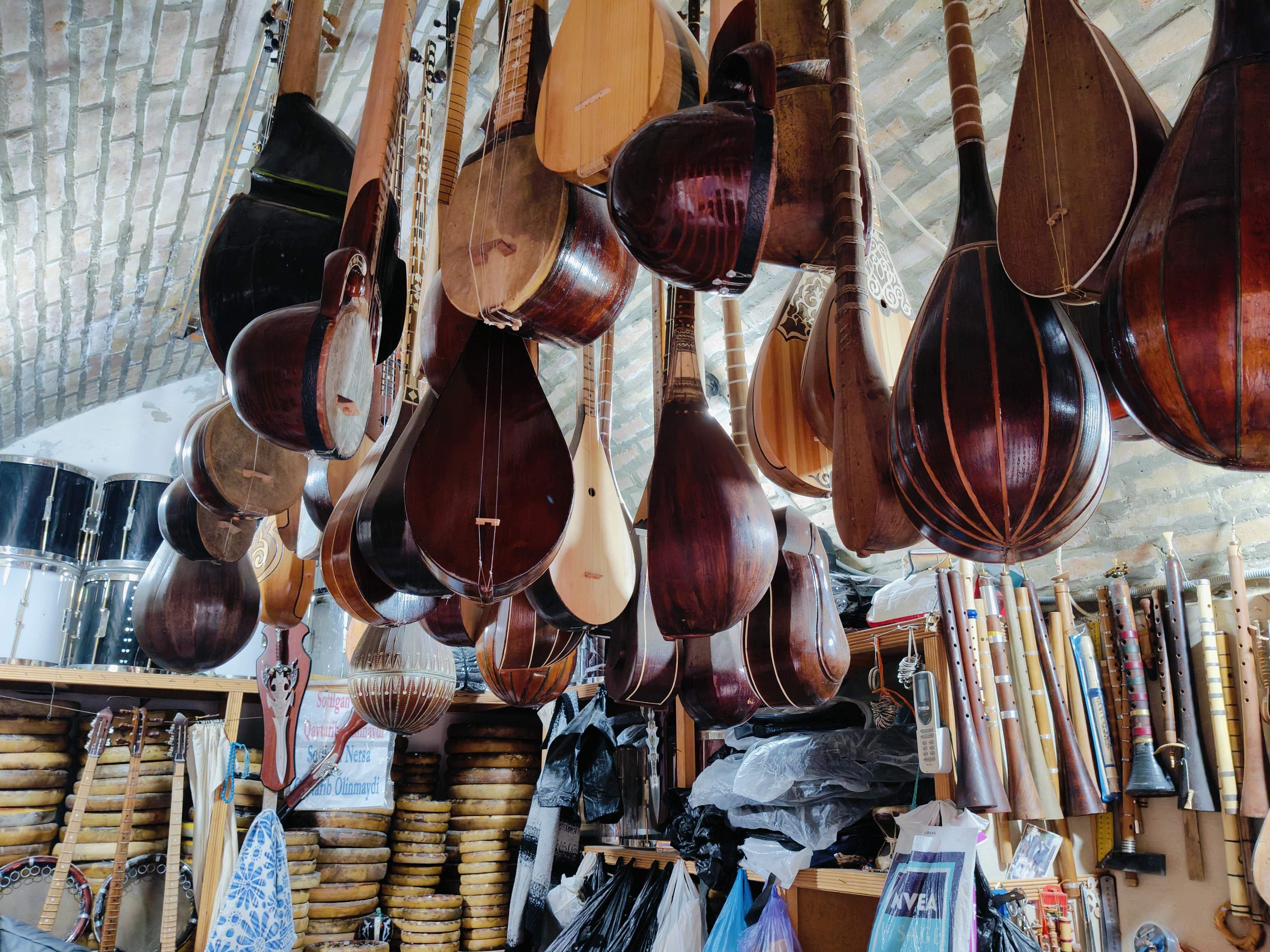 Traditional Uzbek musical instruments shop in Bukhara bazaar - authentic Silk Road trading experience with handcrafted instruments