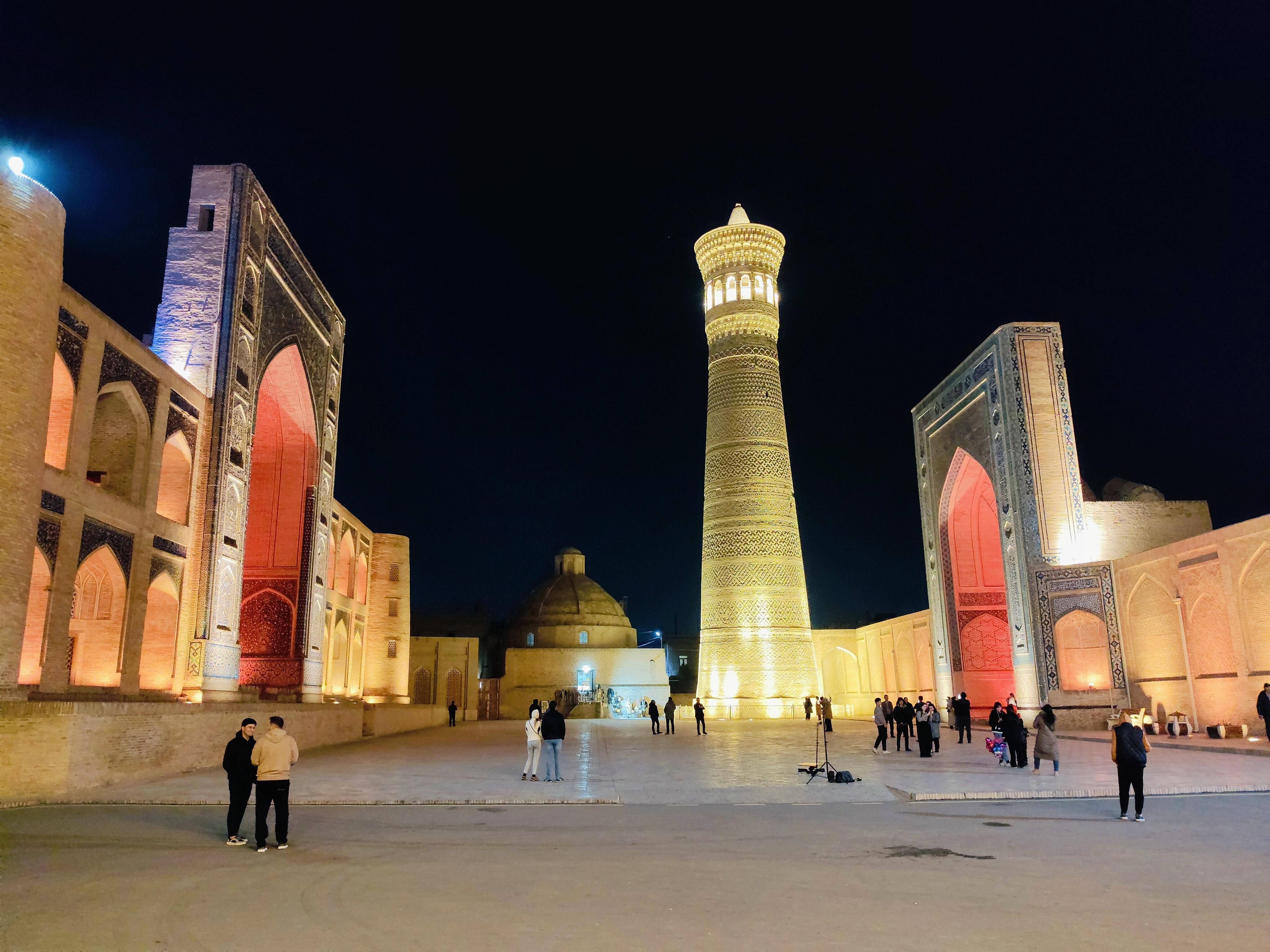 Illuminated Kalon Square and 12th-century minaret at night in Bukhara - historic structure spared by Genghis Khan during 1220 conquest of the city