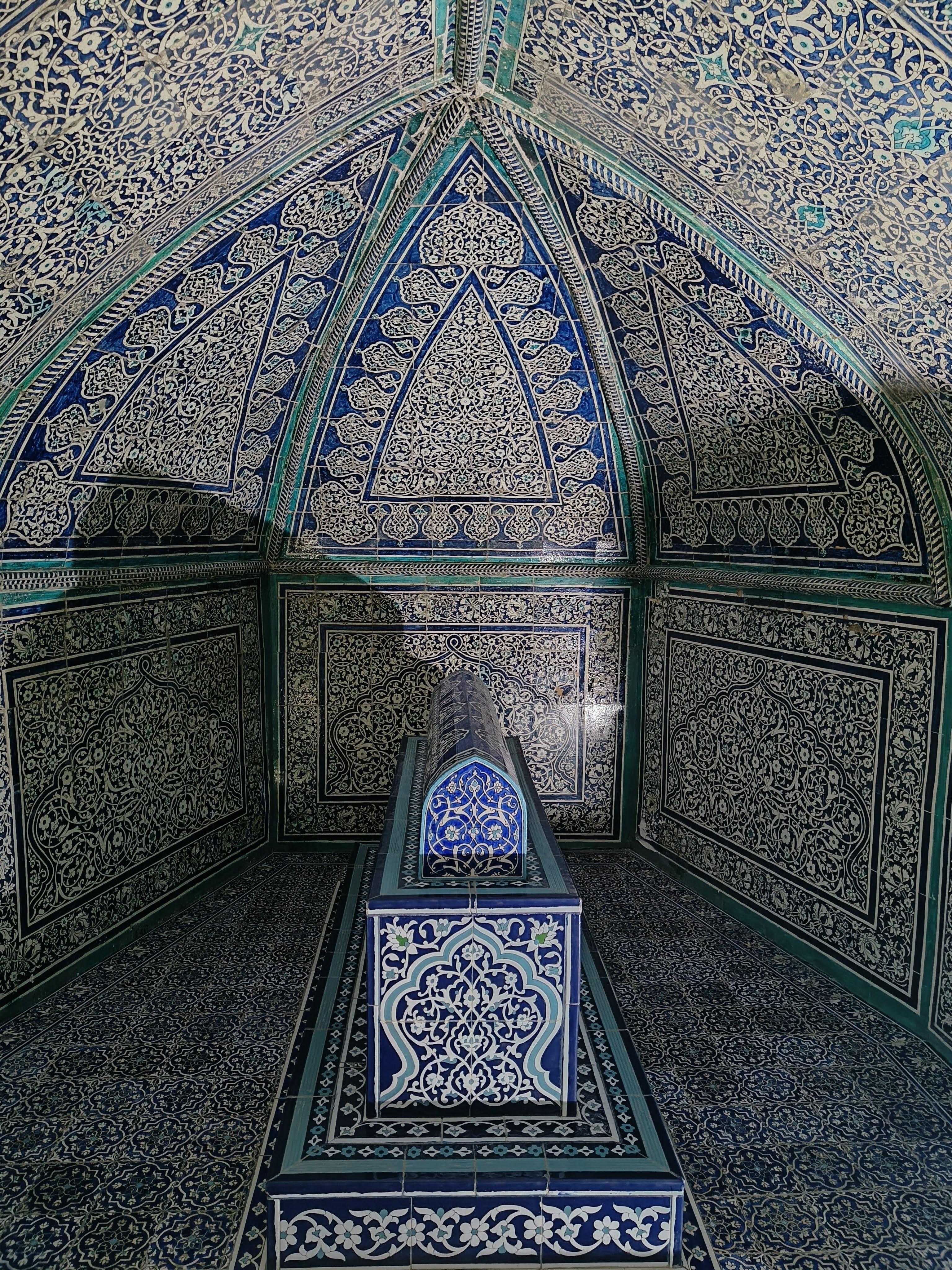 Interior of Pakhlavan Makhmud Mausoleum with intricate blue ceramic tilework and golden dome - masterpiece of Islamic architecture in Khiva showcasing exceptional Uzbek craftsmanship