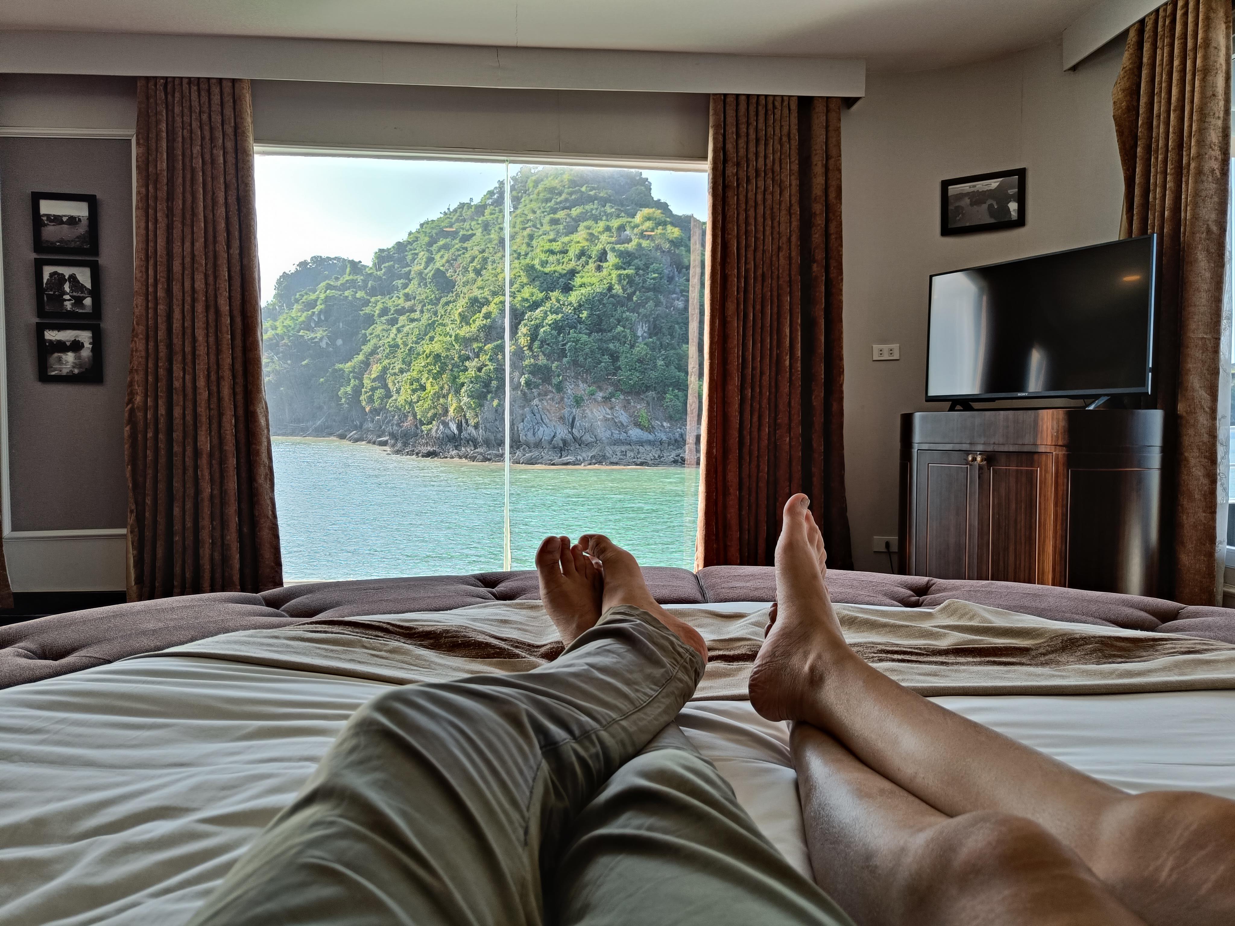 Kayaking adventure between towering karst formations in Ha Long Bay, a top outdoor activity in Vietnam